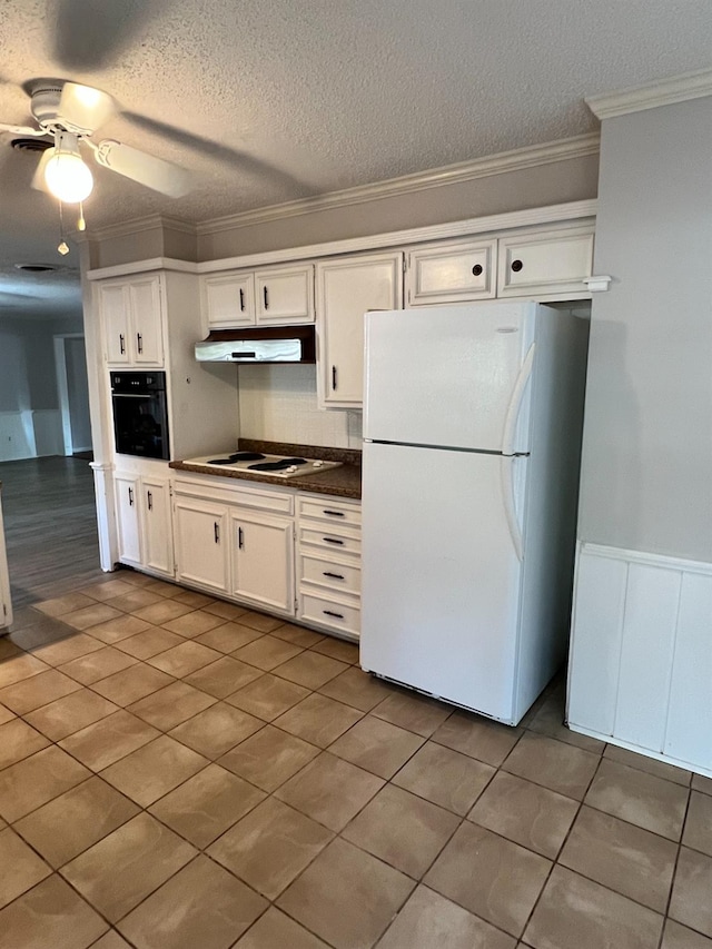 kitchen featuring white cabinetry, ornamental molding, white appliances, ceiling fan, and a textured ceiling