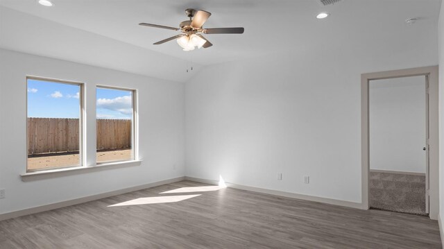 unfurnished room featuring hardwood / wood-style flooring, ceiling fan, and lofted ceiling