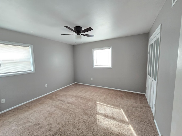 spare room with ceiling fan and carpet flooring