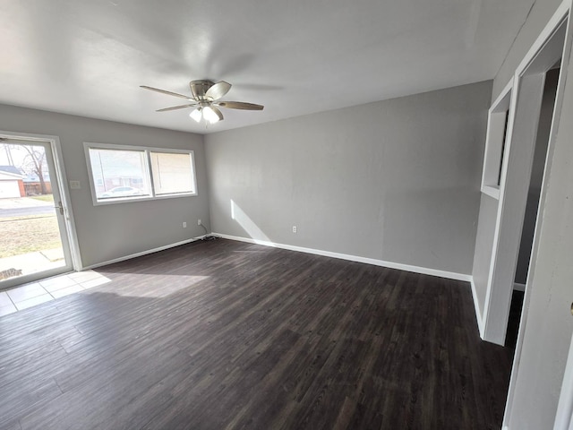 spare room with ceiling fan and dark hardwood / wood-style flooring