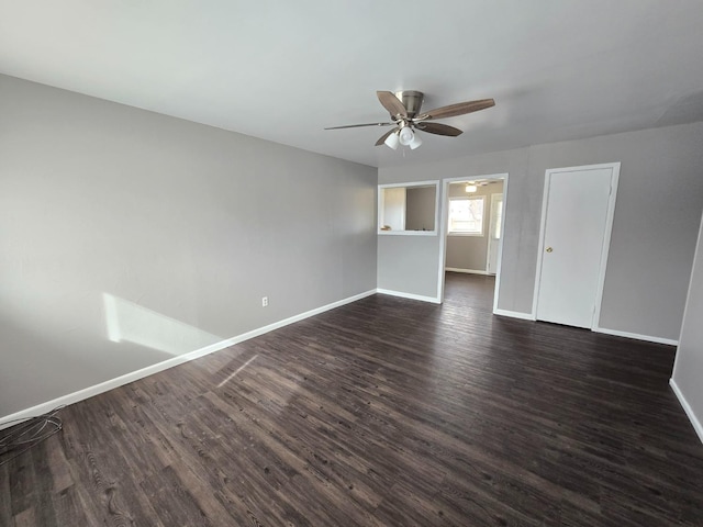 spare room featuring ceiling fan and dark hardwood / wood-style flooring