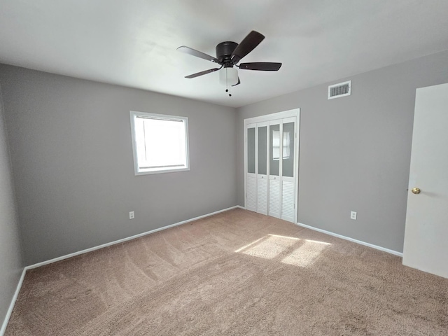 carpeted empty room with ceiling fan