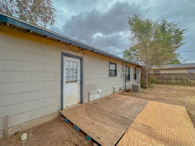 exterior space with central AC unit and a wooden deck