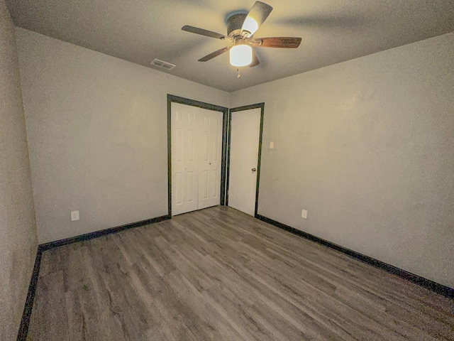 unfurnished bedroom with wood-type flooring and ceiling fan