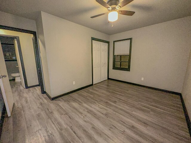 unfurnished bedroom featuring ceiling fan, light wood-type flooring, and a closet