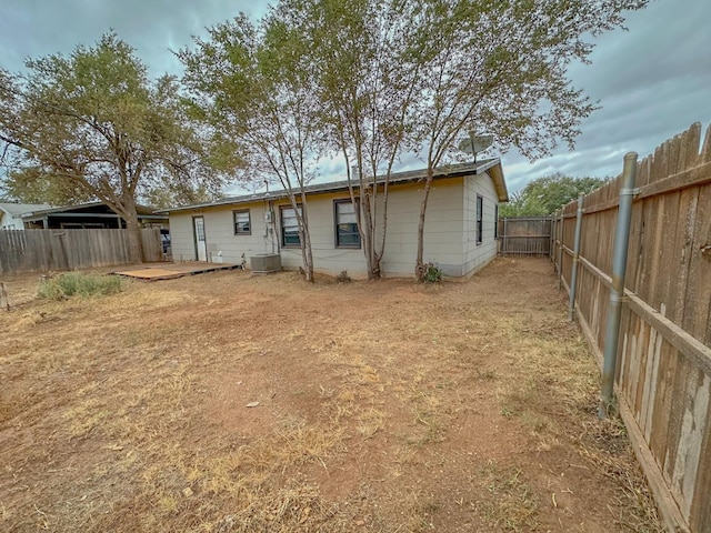 rear view of house featuring central AC