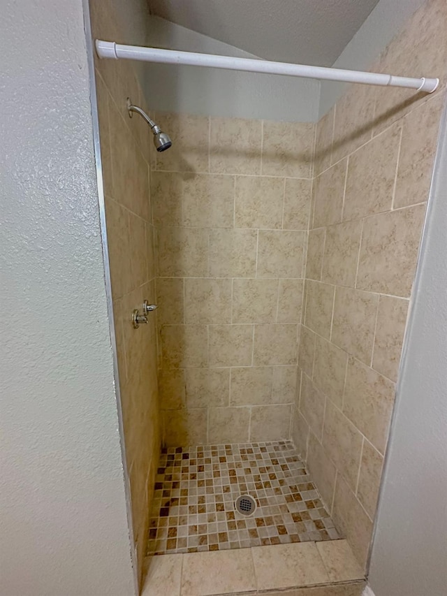 bathroom with a tile shower