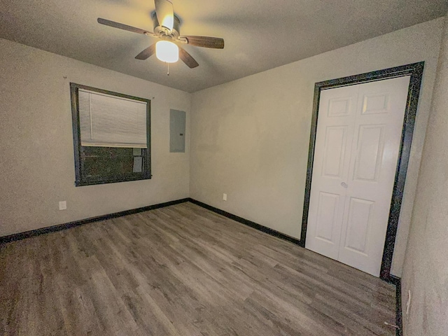 interior space with hardwood / wood-style flooring, ceiling fan, and electric panel