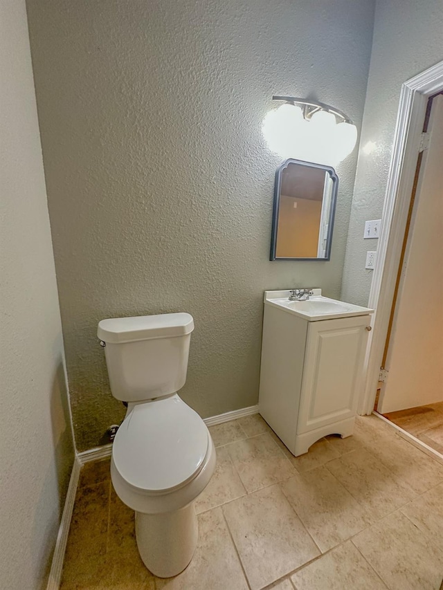 bathroom with vanity, tile patterned floors, and toilet