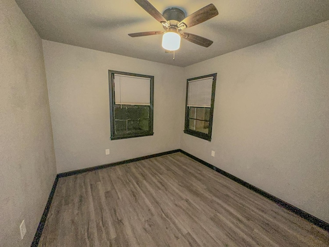 spare room featuring ceiling fan and hardwood / wood-style floors