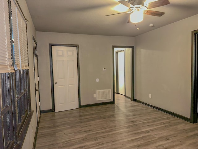 unfurnished room featuring hardwood / wood-style flooring and ceiling fan