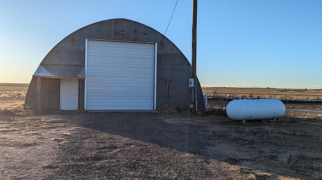 view of garage at dusk