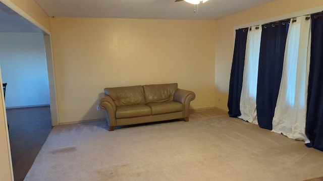 sitting room with light colored carpet and ceiling fan