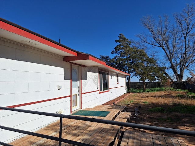 view of side of home featuring a wooden deck