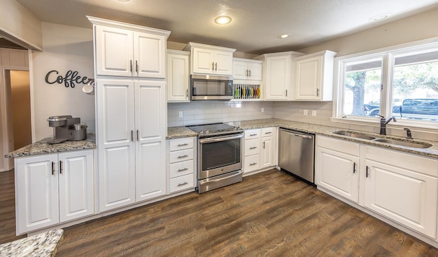 kitchen with white cabinetry, sink, and stainless steel appliances