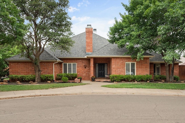 314 York Ave, Lubbock, TX 79416 - view of front of property featuring a shingled roof, brick siding, and a chimney