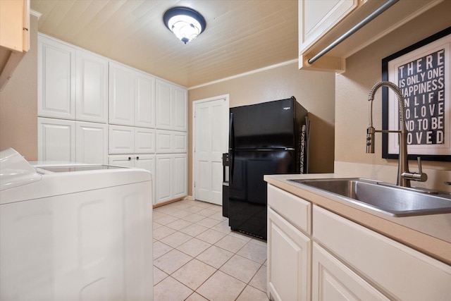 314 York Ave, Lubbock, TX 79416 - laundry area with washer / dryer, light tile patterned floors, and cabinet space