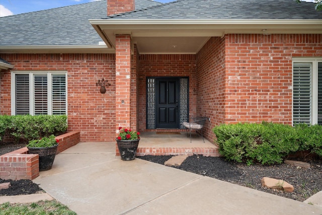 314 York Ave, Lubbock, TX 79416 - entrance to property with a shingled roof, brick siding, and a chimney