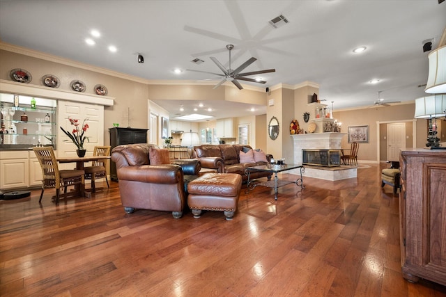314 York Ave, Lubbock, TX 79416 - living room featuring a ceiling fan, a fireplace, ornamental molding, hardwood / wood-style flooring, and recessed lighting