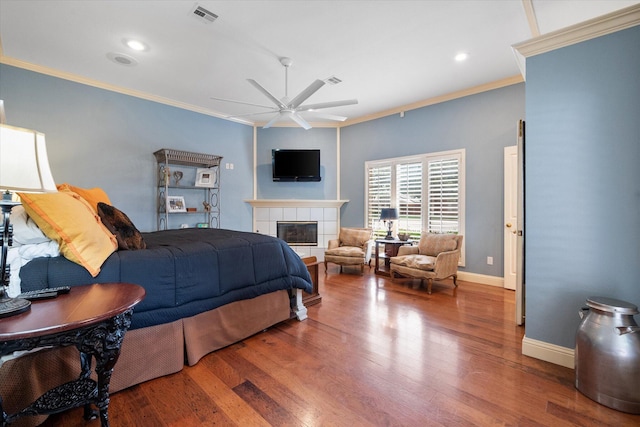 314 York Ave, Lubbock, TX 79416 - bedroom featuring ornamental molding, wood finished floors, a tiled fireplace, recessed lighting, and a ceiling fan