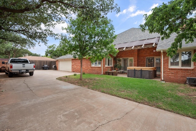 314 York Ave, Lubbock, TX 79416 - view of front of home featuring a hot tub, brick siding, concrete driveway, and roof with shingles