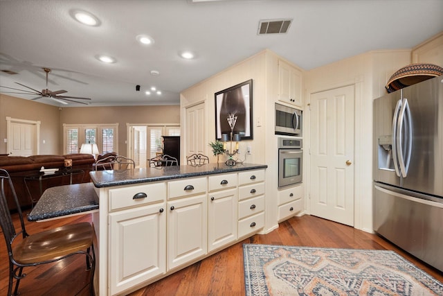 314 York Ave, Lubbock, TX 79416 - kitchen featuring stainless steel appliances, ceiling fan, a peninsula, wood finished floors, and recessed lighting