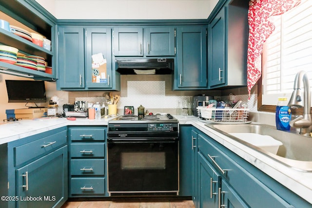 4610 63rd St, Lubbock, TX 79414 - kitchen with black / electric stove, exhaust hood, light countertops, and blue cabinetry