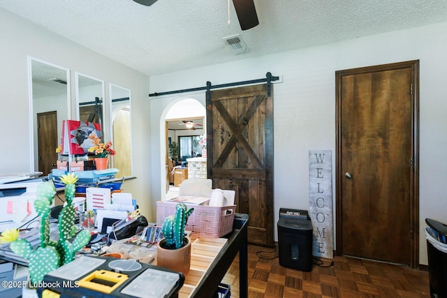 4610 63rd St, Lubbock, TX 79414 - office with ceiling fan, a barn door, arched walkways, and a textured ceiling