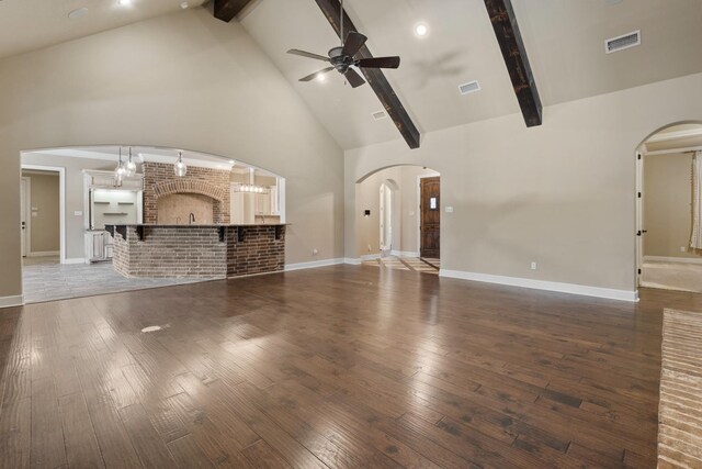 unfurnished living room with ceiling fan, high vaulted ceiling, dark hardwood / wood-style floors, and beam ceiling