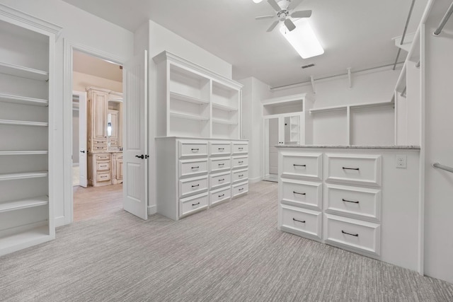 spacious closet featuring light carpet and ceiling fan