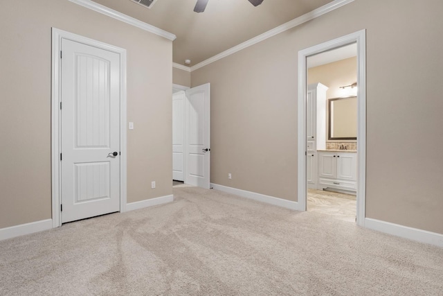 unfurnished bedroom featuring ceiling fan, ensuite bath, ornamental molding, and light carpet