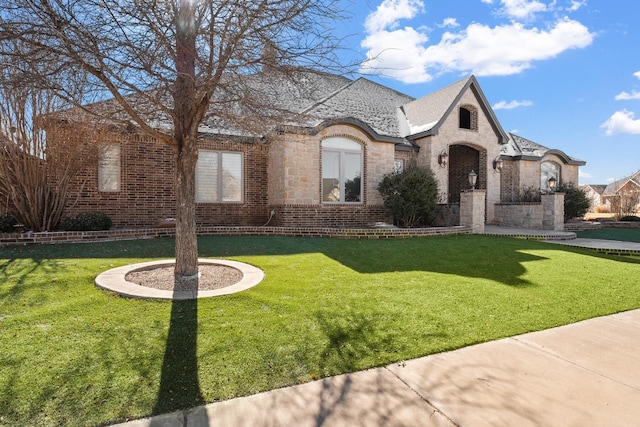 french country style house featuring a front lawn