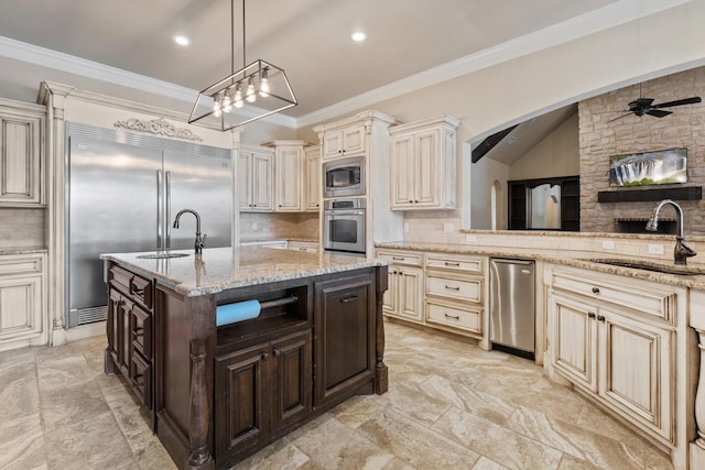 kitchen featuring pendant lighting, sink, stainless steel appliances, dark brown cabinetry, and light stone counters