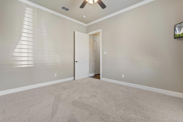 spare room featuring ceiling fan, ornamental molding, and carpet flooring