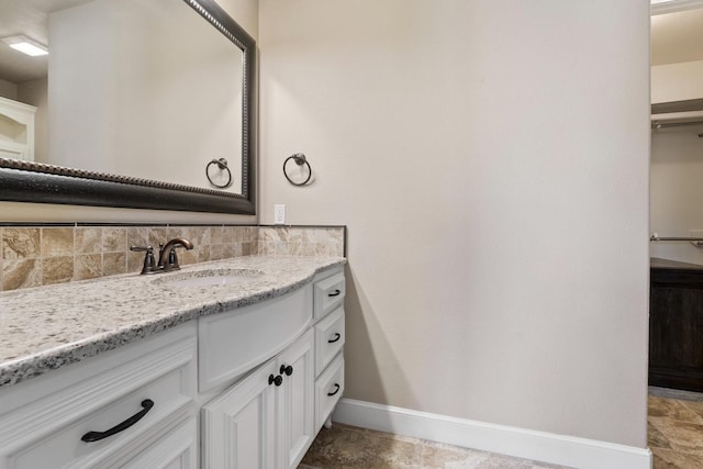 bathroom featuring tasteful backsplash and vanity