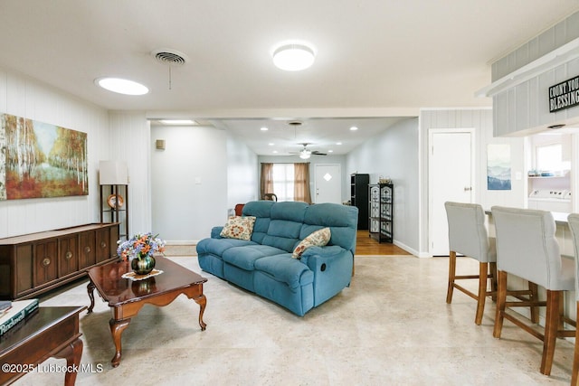 2806 58th St, Lubbock, TX 79413 - living room featuring ceiling fan, baseboards, and washer / dryer