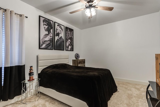 bedroom with ceiling fan and light carpet