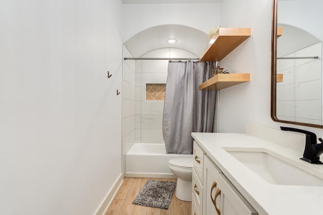 full bathroom featuring vanity, hardwood / wood-style floors, toilet, and shower / bath combo