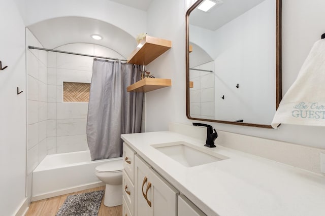 full bathroom featuring shower / bath combination with curtain, wood-type flooring, toilet, and vanity