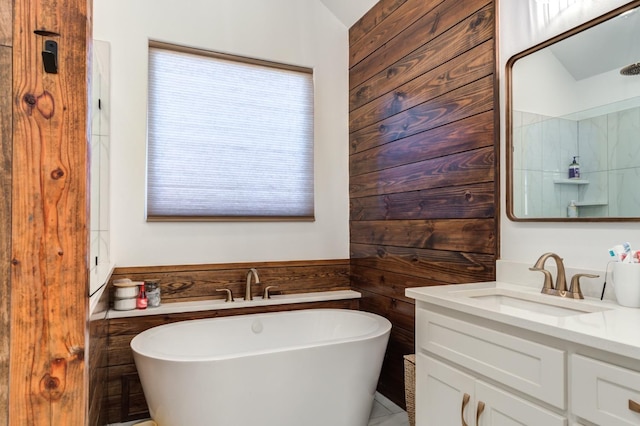 bathroom with wooden walls, vanity, and a bath