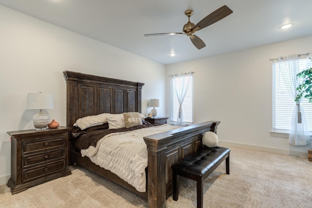 bedroom featuring light carpet and ceiling fan