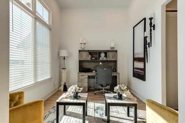 home office with light hardwood / wood-style floors