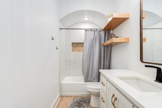 full bathroom featuring vanity, wood-type flooring, shower / tub combo, and toilet