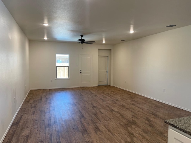 unfurnished room with dark hardwood / wood-style floors, a textured ceiling, and ceiling fan