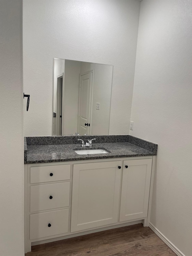 bathroom featuring vanity and hardwood / wood-style flooring