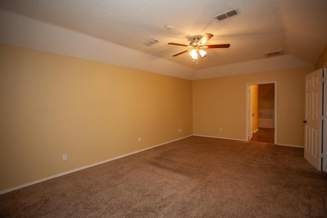 unfurnished bedroom with ensuite bath, lofted ceiling, carpet, and a textured ceiling