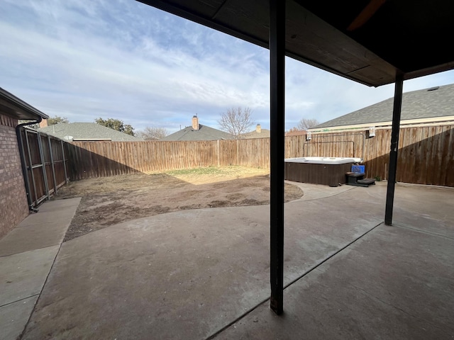 4910 102nd St, Lubbock, TX 79424 - fenced backyard featuring a hot tub and a patio
