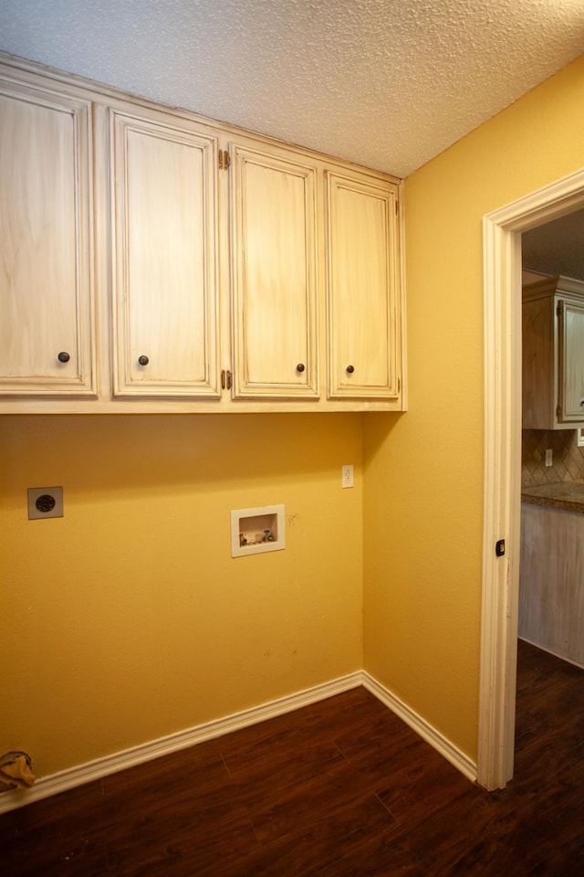 laundry room featuring dark wood-type flooring, hookup for a washing machine, cabinets, a textured ceiling, and hookup for an electric dryer