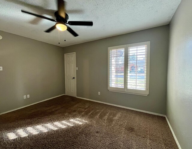 4910 102nd St, Lubbock, TX 79424 - empty room with dark colored carpet, a ceiling fan, and a textured ceiling