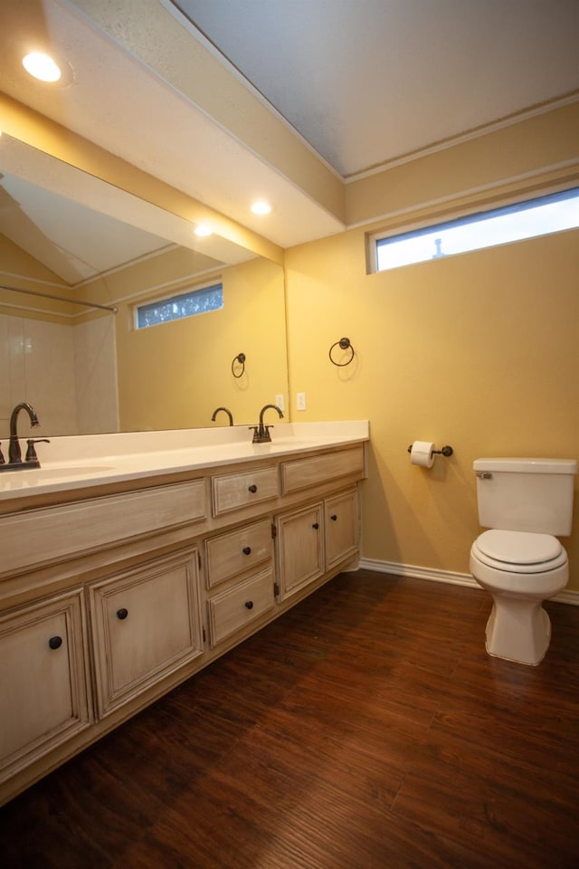 bathroom featuring lofted ceiling, vanity, toilet, and wood-type flooring